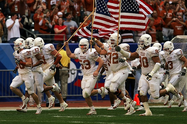 Texas football team running onto the field