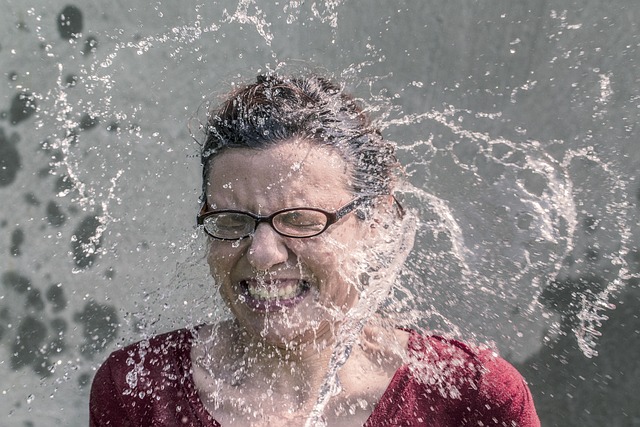 image of a woman being splashed in the face with water