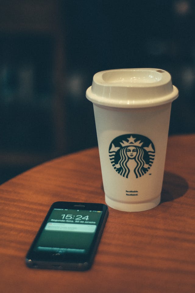 image of a starbucks cup and a cell phone