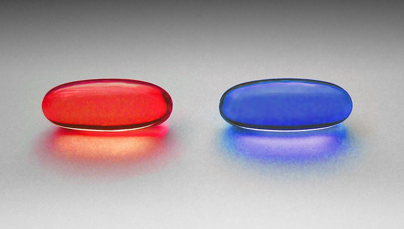 image of a red pill and a blue pill on a blank background