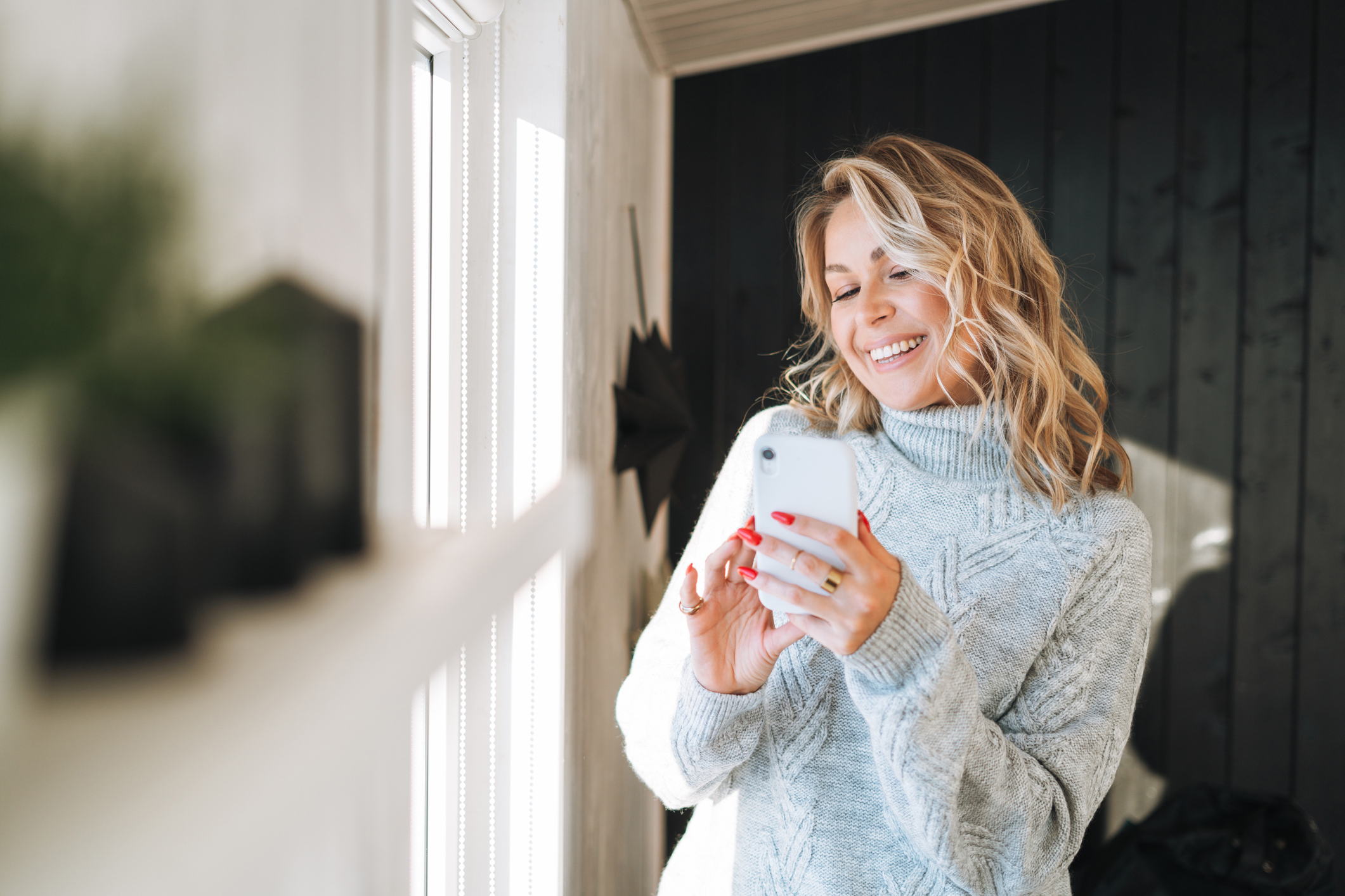 Interior designer looking at her social media account converting into paying customers