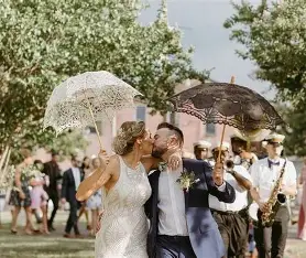 Wedding couple using umberella for shade