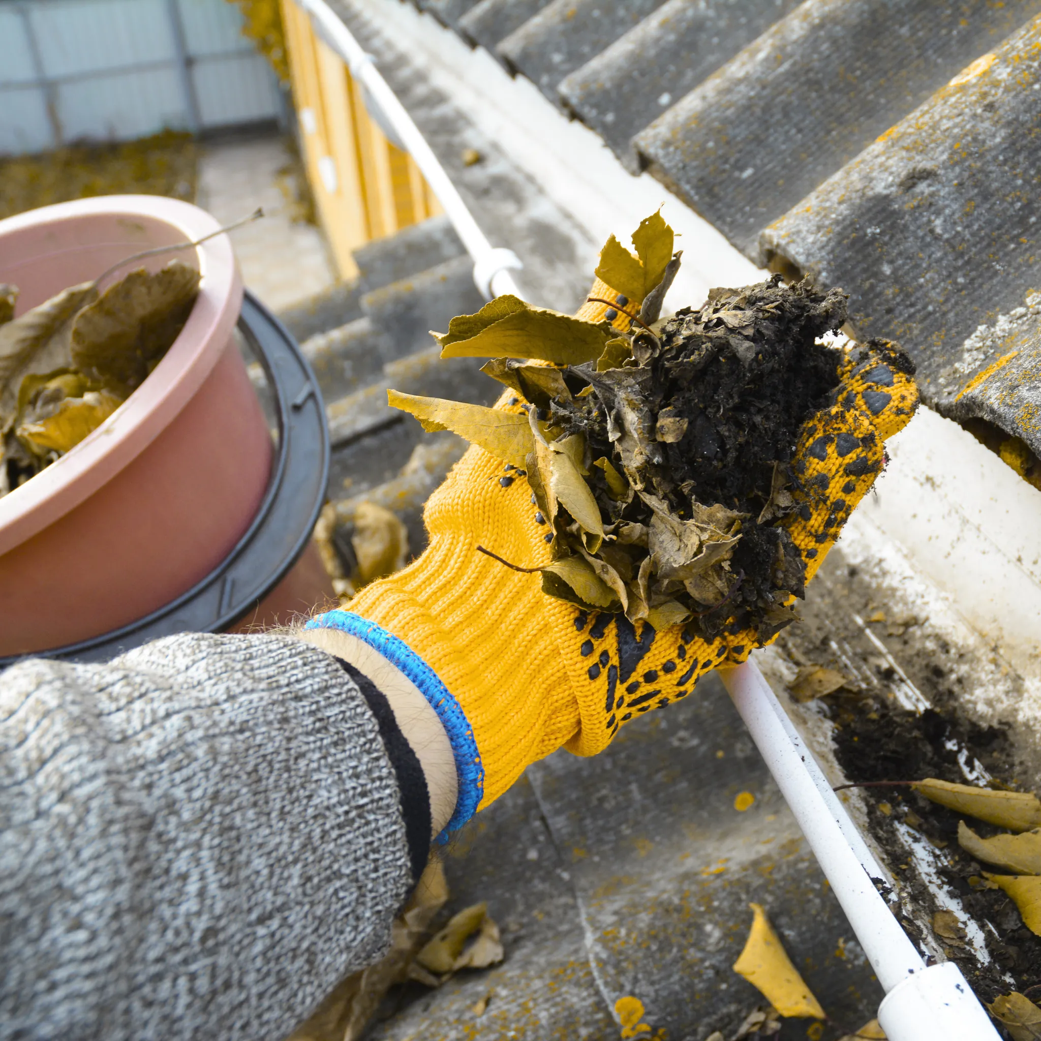 A professional repairing a sagging gutter on a home.