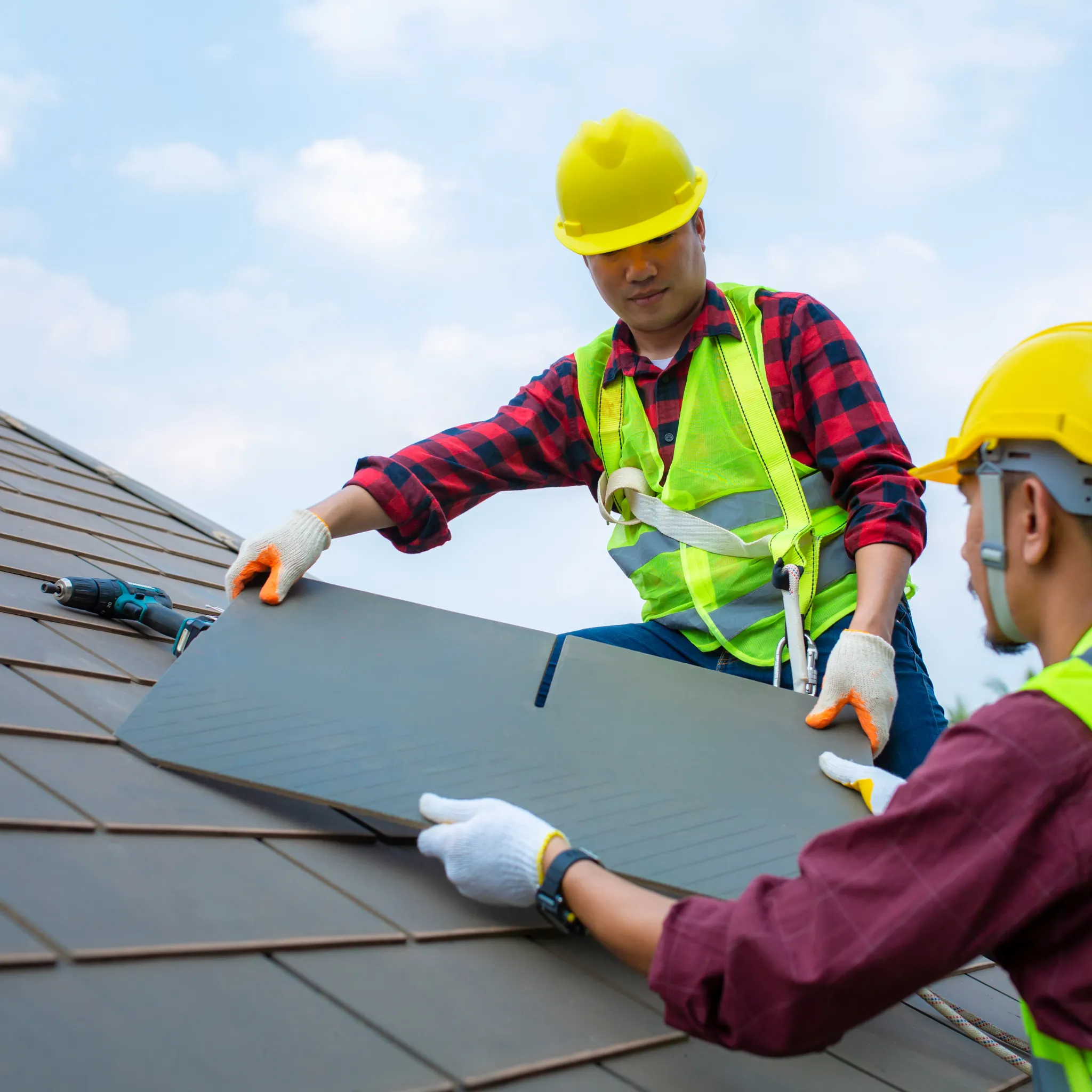 A commercial roof repair expert on a business roof.