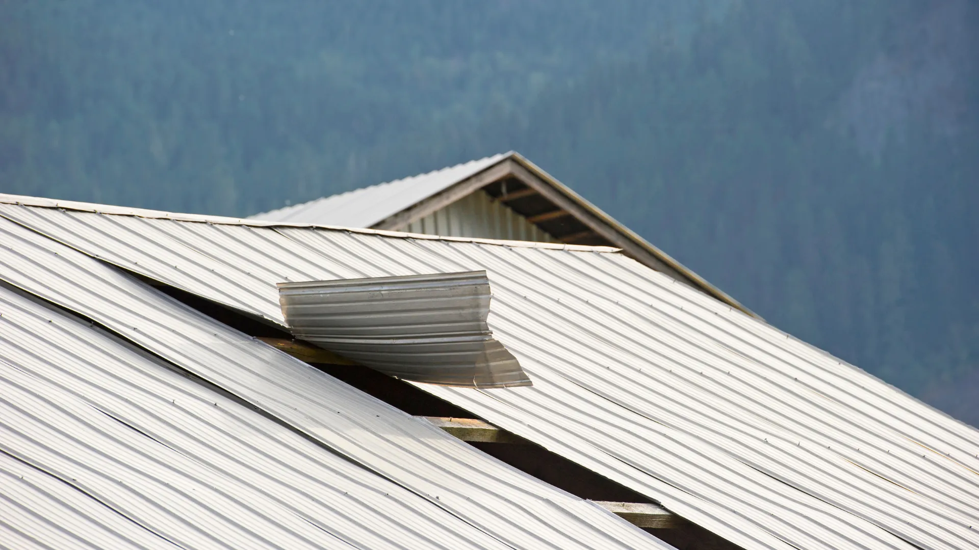 A professional repairing a roof after a wind storm.