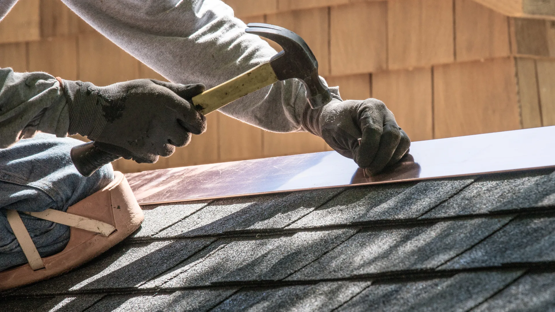 A freshly installed asphalt shingle roof on a modern building.
