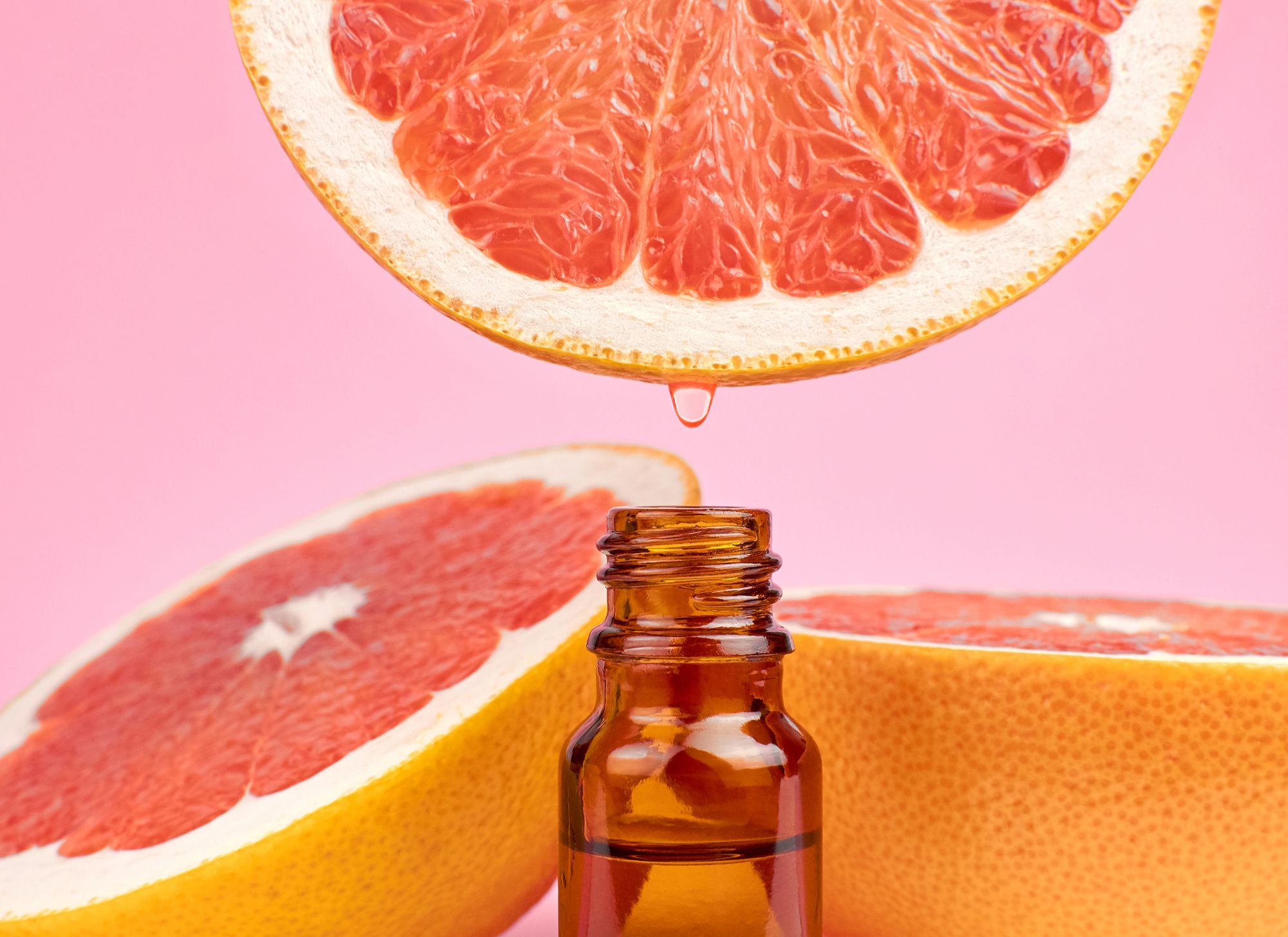 grapefruit and bottle of essential oil