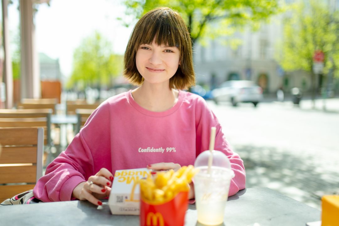 Smiling teenage girl eating McDonald's Smiling teenage girl eating McDonald's