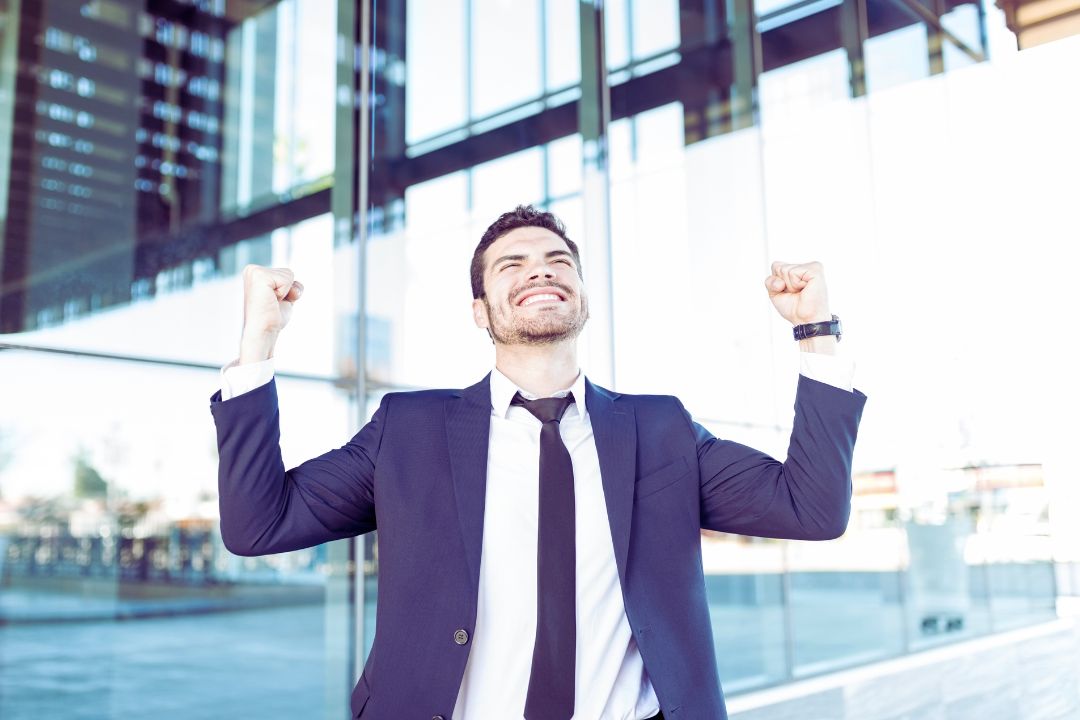 Happy male CEO celebrating victory Happy male CEO celebrating victory
