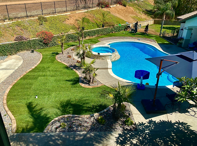 Artificial turf installed around a backyard pool area, offering a clean, low-maintenance landscape with a lush green lawn and a relaxing poolside environment. Artificial turf installed around a backyard pool area, offering a clean, low-maintenance landscape with a lush green lawn and a relaxing poolside environment.