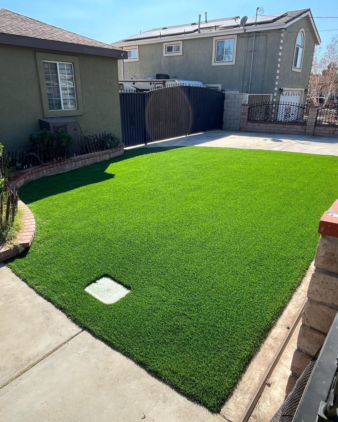 Artificial turf installed in a backyard with a shaded seating area, offering a lush, green lawn that is low-maintenance and perfect for outdoor relaxation. Artificial turf installed in a backyard with a shaded seating area, offering a lush, green lawn that is low-maintenance and perfect for outdoor relaxation.