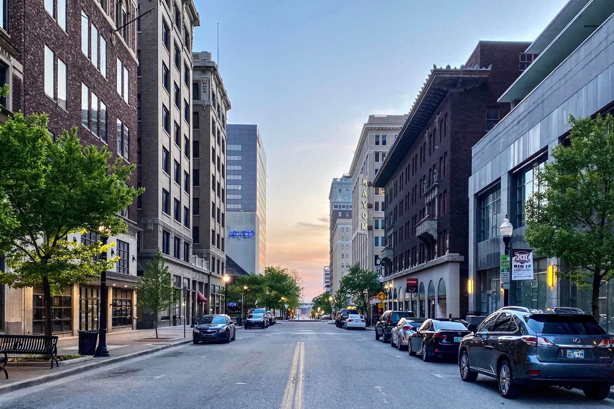 Tulsa skyline at sunset with moving boxes inside a modern living room representing home buying and selling trends in 2025 Tulsa skyline at sunset with moving boxes inside a modern living room representing home buying and selling trends in 2025