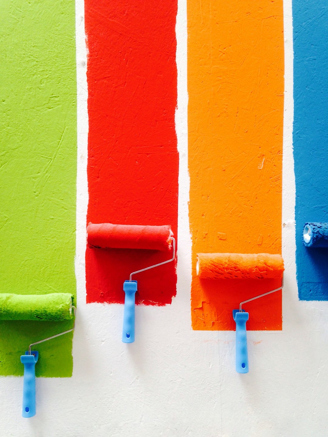 rollers full of paint on a wall rollers full of paint on a wall