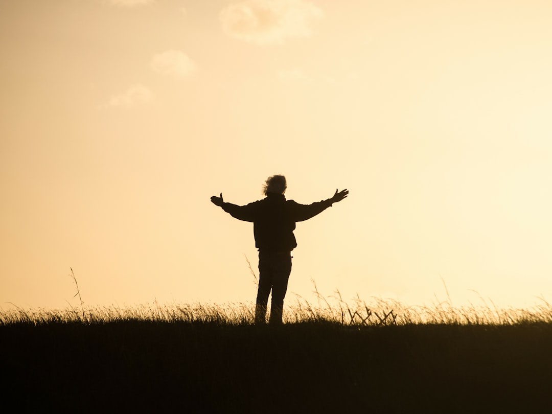 man with arms stretched out in the sun man with arms stretched out in the sun