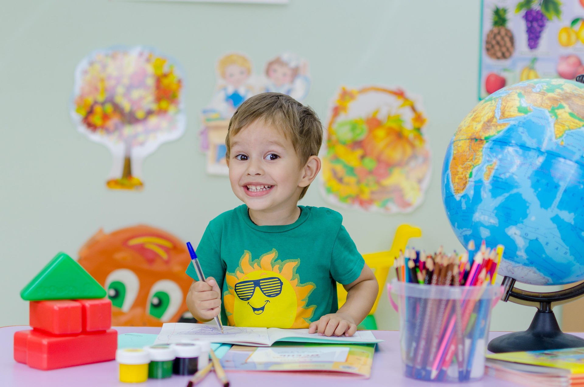 child surrounded by art supplies child surrounded by art supplies