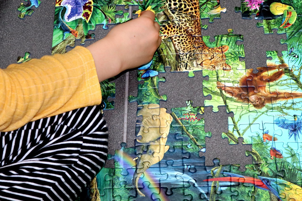 child working a jigsaw puzzle child working a jigsaw puzzle