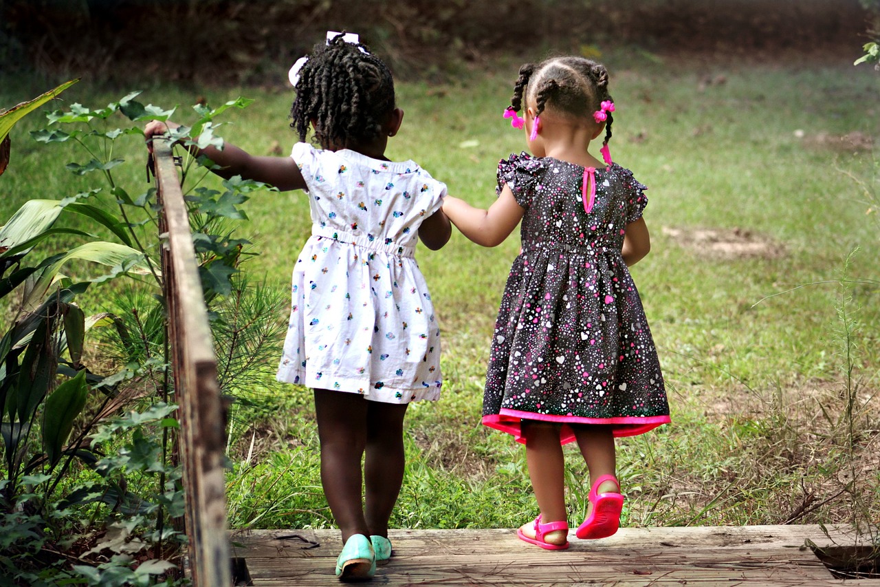 girls helping each other cross a bridge girls helping each other cross a bridge