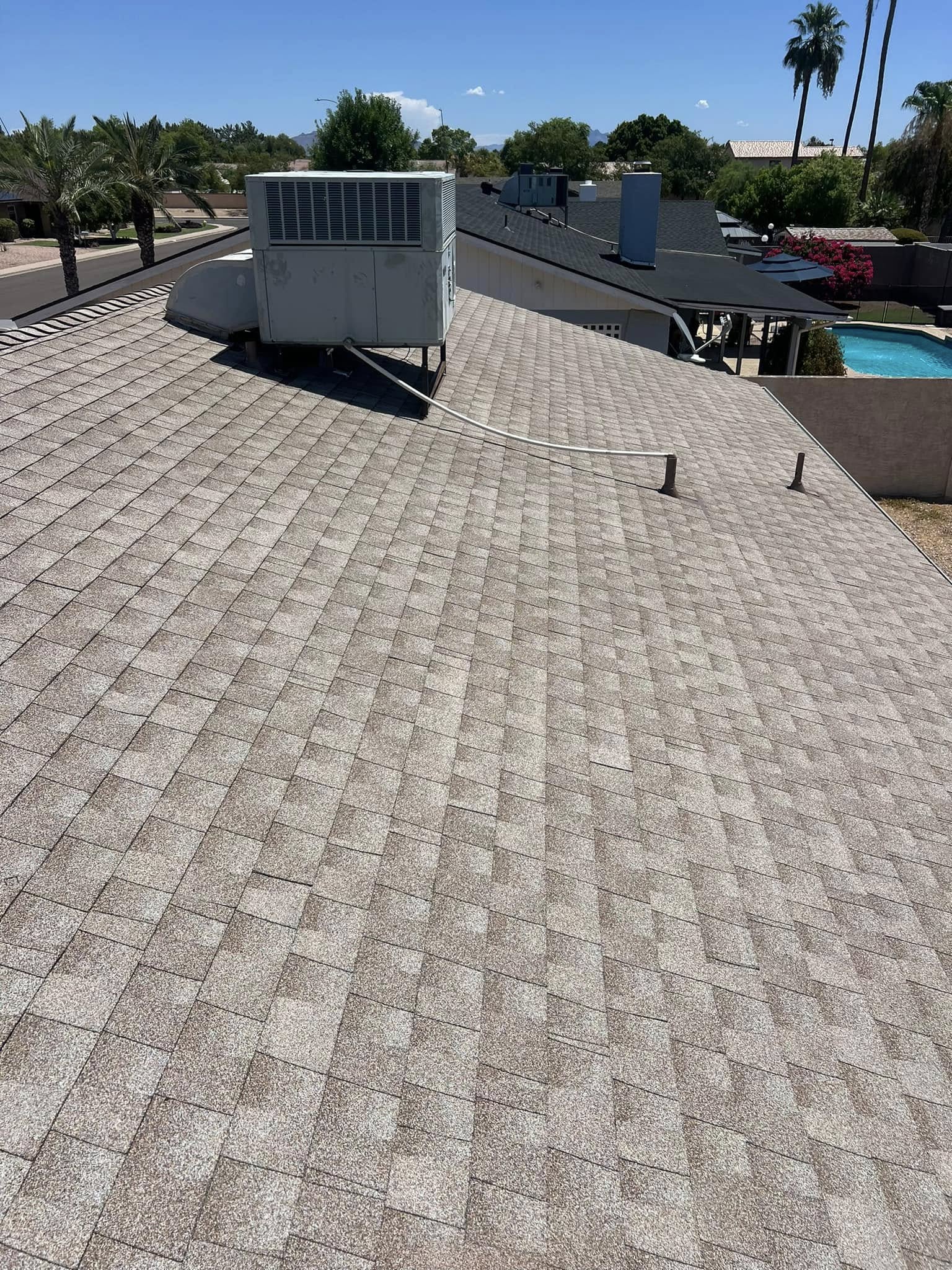 General roofing crew installing shingles on a residential roof