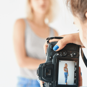 A camera showing the screen of a blonde woman having a photo shoot