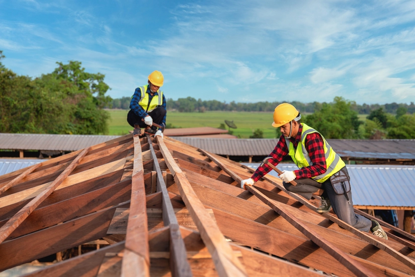 Roofers working on frame for roof