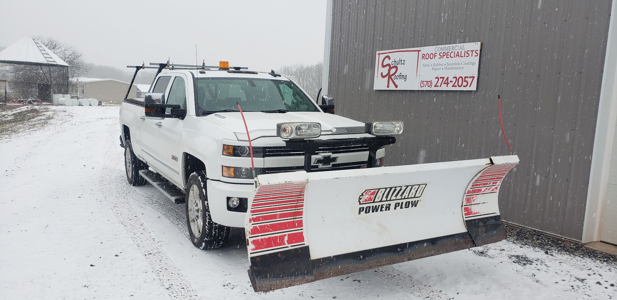 Commercial snow removal truck and flat roof inspection in Central Pennsylvania winter Commercial snow removal truck and flat roof inspection in Central Pennsylvania winter