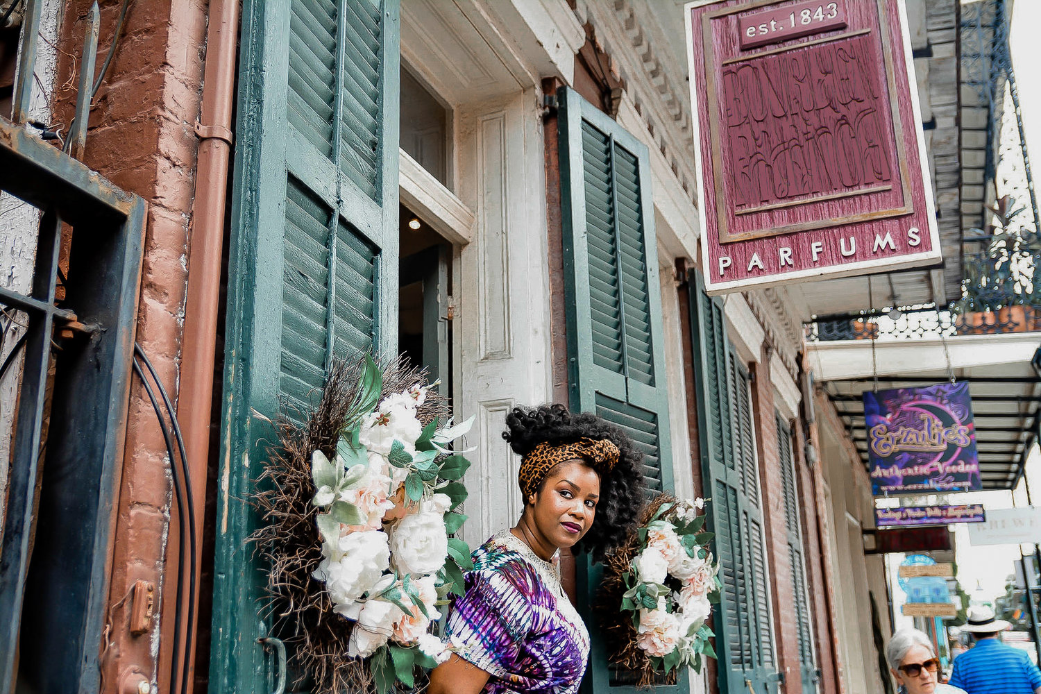 Black Woman standing in front of flowers 