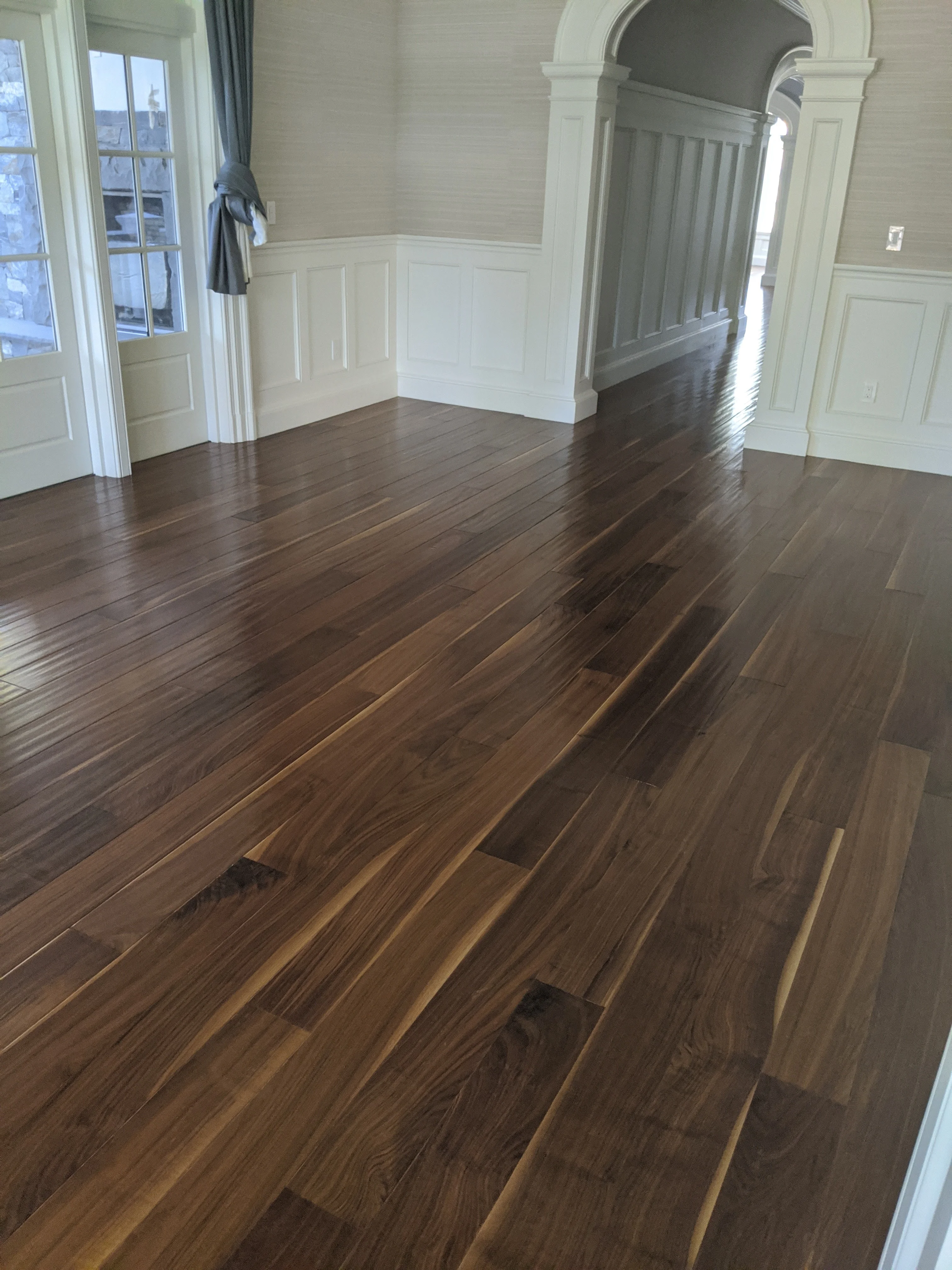 Professional hardwood floor repair showing board replacement