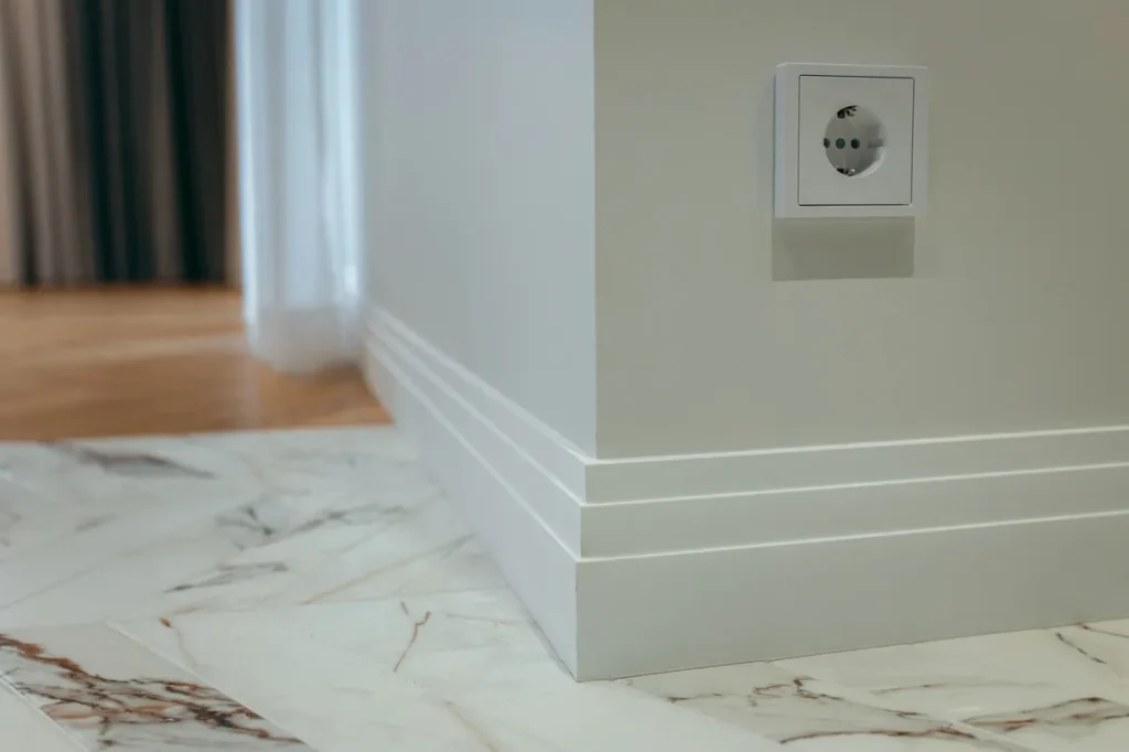 Professional baseboard installation with perfect corners and finish