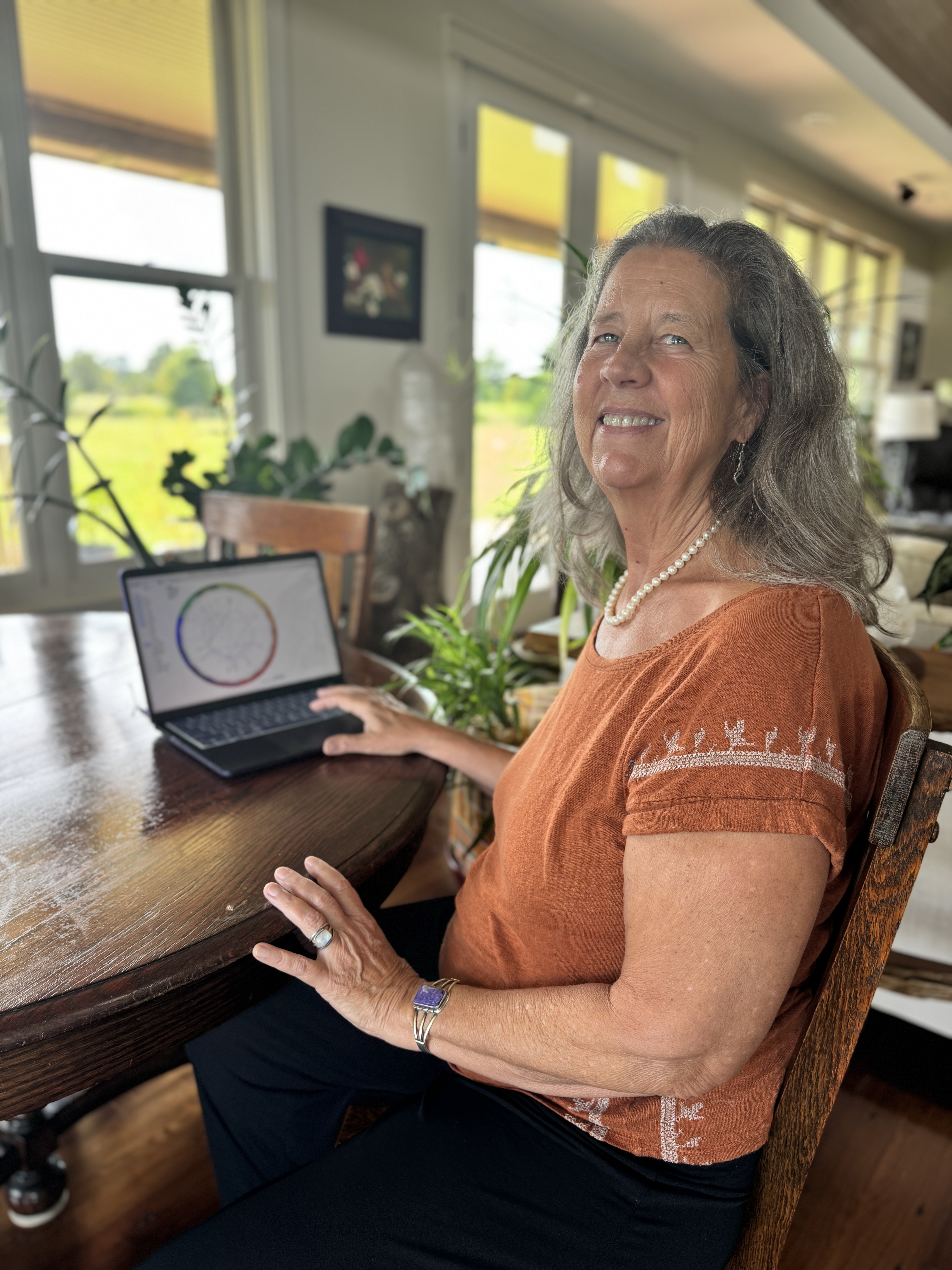 Sarah smiling with astrology chart