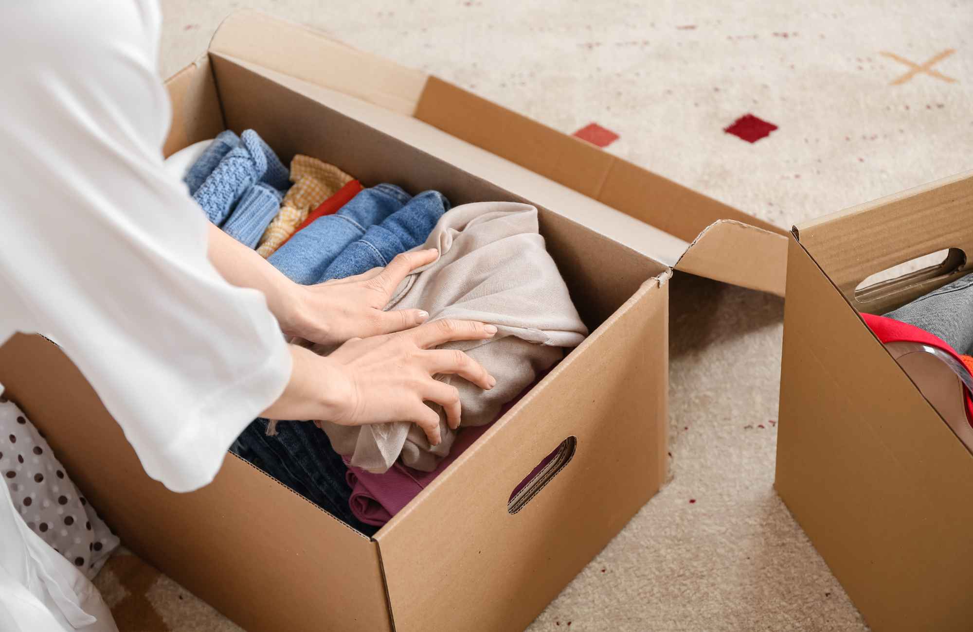 shannon's-organizing-solutions-kingman-az-2026-new-year-home-reset-woman-storing-clothing-in-box-efficient-home-organizing shannon's-organizing-solutions-kingman-az-2026-new-year-home-reset-woman-storing-clothing-in-box-efficient-home-organizing