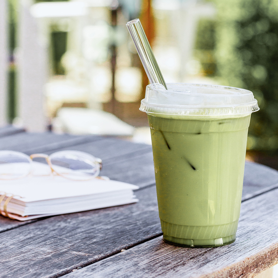 single use plastic cup filled with matcha on a wooden table single use plastic cup filled with matcha on a wooden table