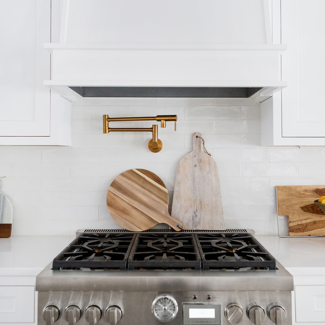 stainless steel oven range with wooden cutting boards displayed behind it. stainless steel oven range with wooden cutting boards displayed behind it.