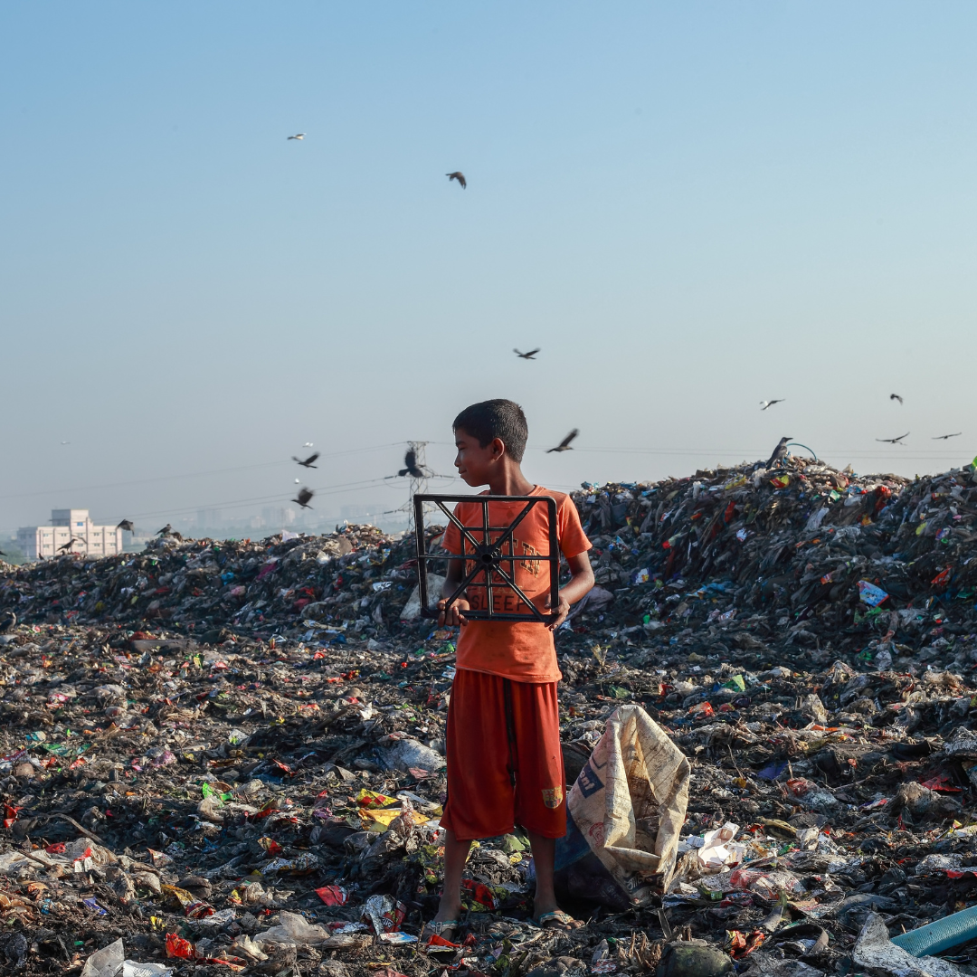 little boy standing in the middle of a landfill little boy standing in the middle of a landfill