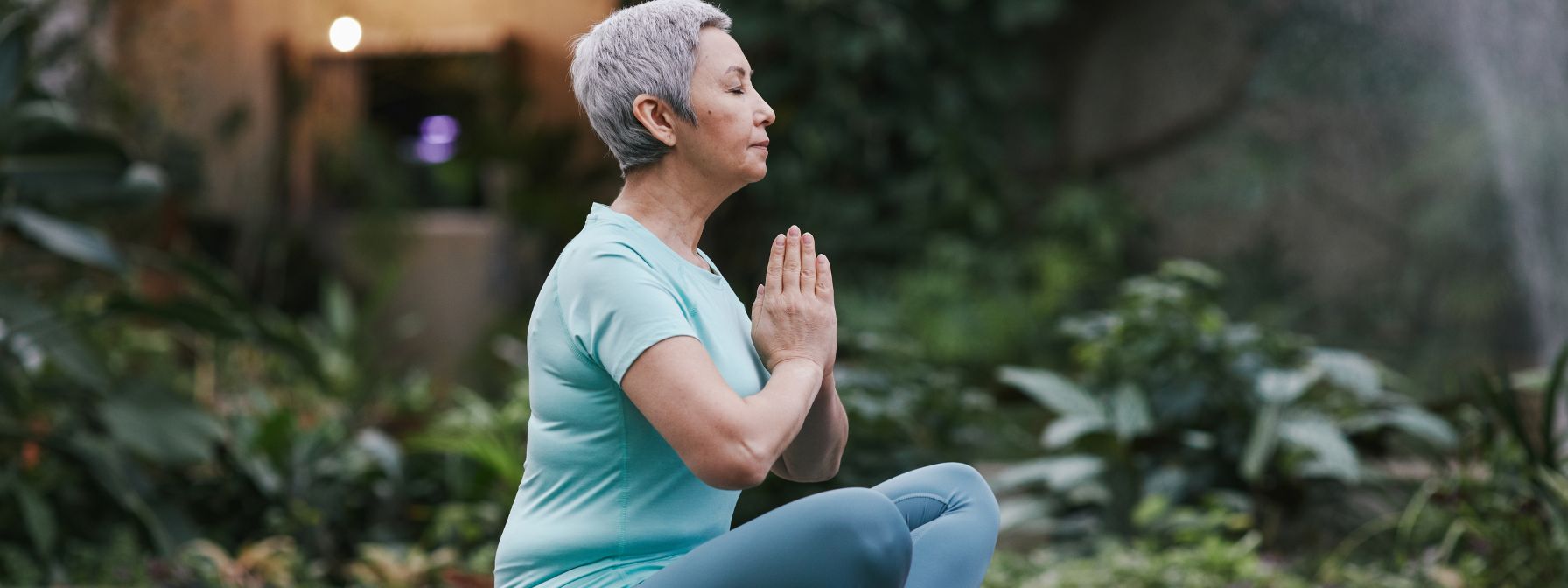 Older woman practicing meditation and yoga for hormone balance, stress reduction, and healthy body fat management Older woman practicing meditation and yoga for hormone balance, stress reduction, and healthy body fat management