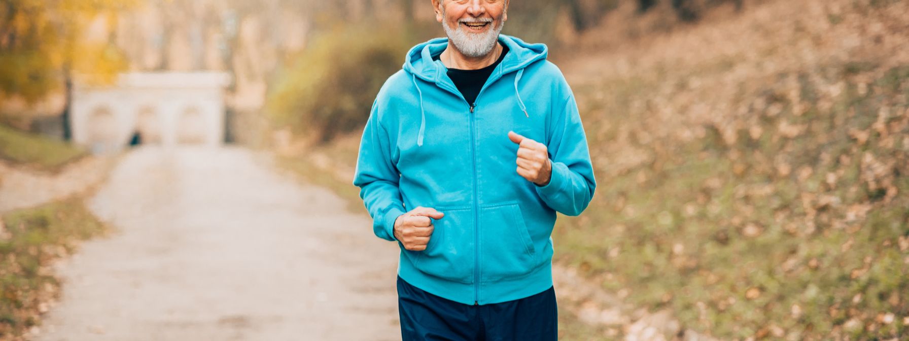 Older man jogging outdoors to reduce body fat and support healthy testosterone levels through exercise Older man jogging outdoors to reduce body fat and support healthy testosterone levels through exercise