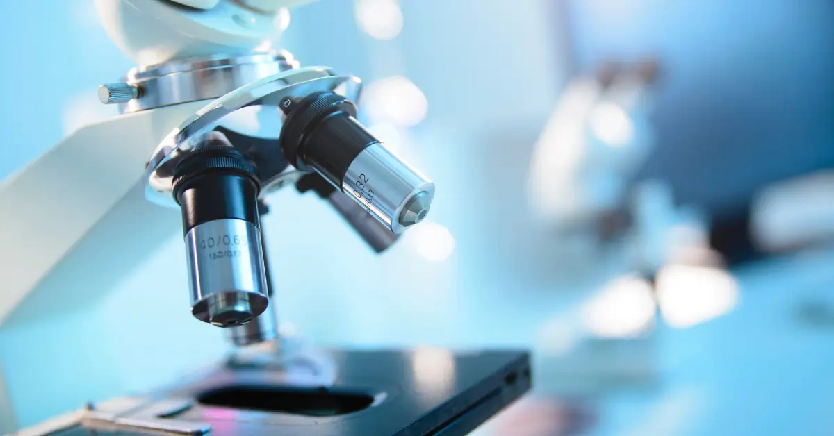 Close-up of a laboratory microscope used for research on bioidentical testosterone and hormone therapy.