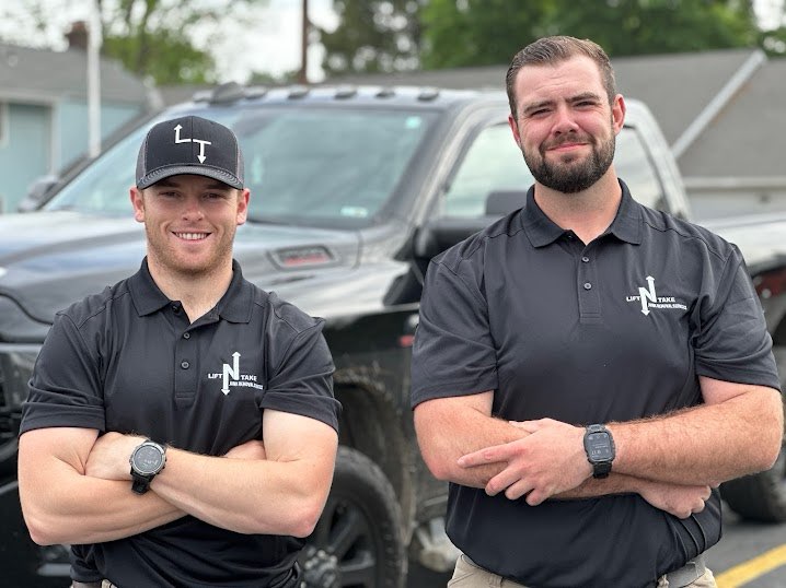 Lift N Take owners smiling with their truck