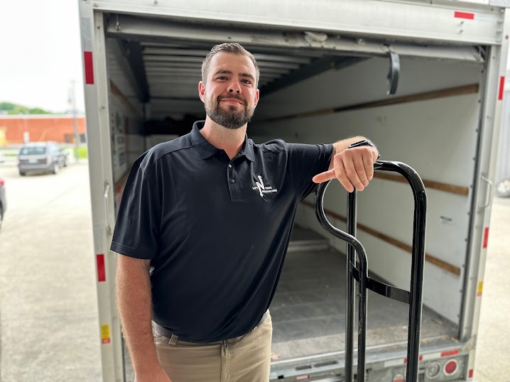 Lift N Take field crew smiling in front of the truck