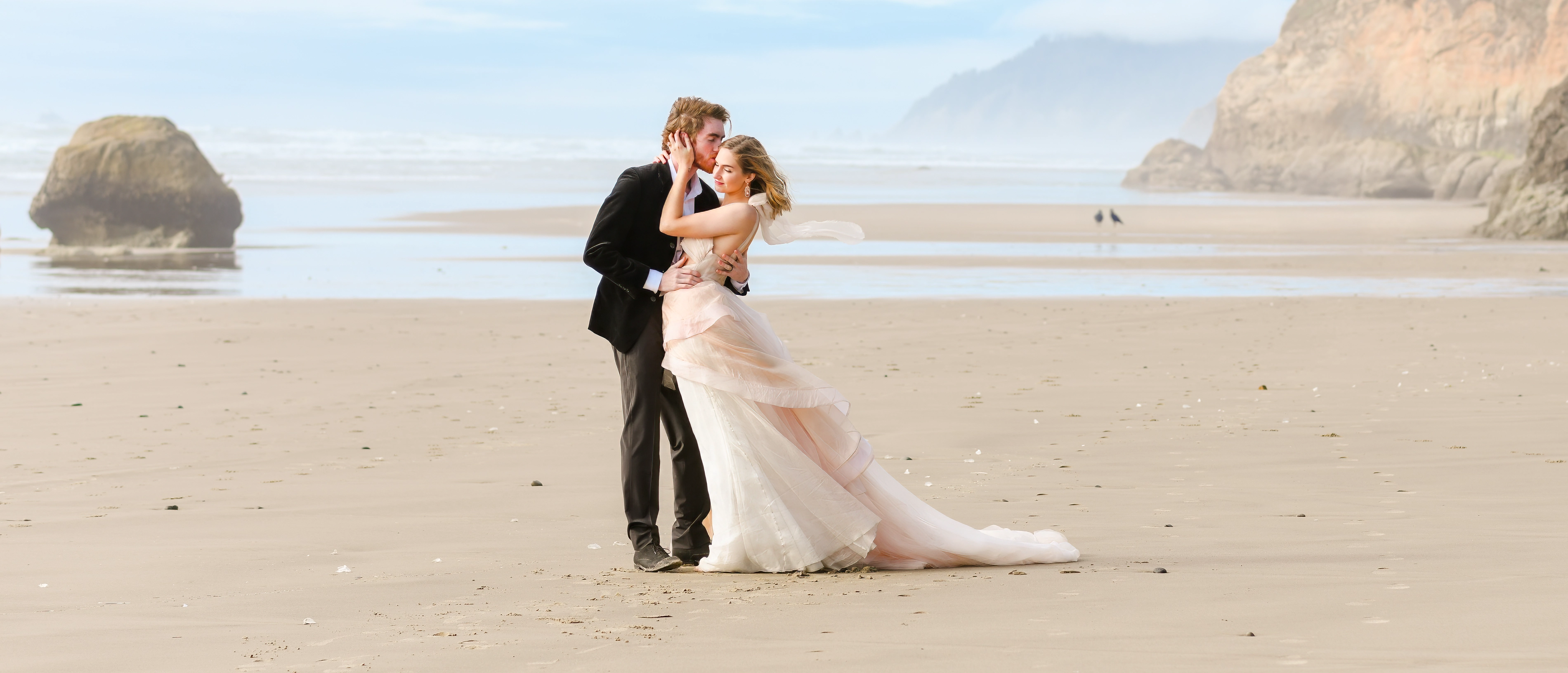 Couple embracing in the sand during low tide. Couple embracing in the sand during low tide.