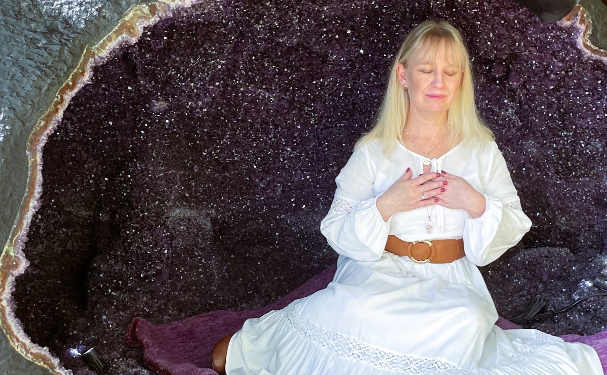 Woman sitting peacefully in an amethyst cave, symbolising inner wisdom, spiritual connection, and sacred feminine power. Woman sitting peacefully in an amethyst cave, symbolising inner wisdom, spiritual connection, and sacred feminine power.