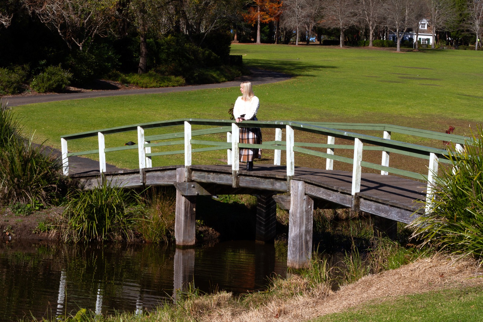 Woman standing on a bridge symbolising the Human Design Incarnation Cross of Duality and the journey of discovering life purpose.