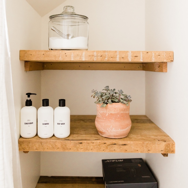 Tidy wooden shelves with coordinating dispensing containers.