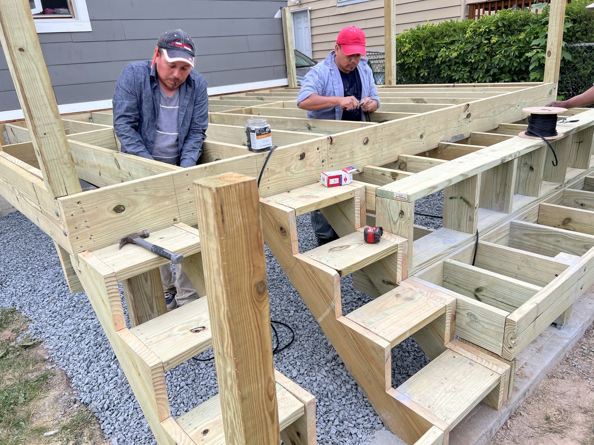 landscape design and installation, expert landscaper installing wooden deck