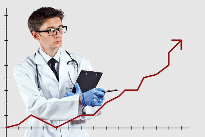 Doctor pointing at graph, symbolizing higher rates of anxiety and depression in autistic people. Doctor pointing at graph, symbolizing higher rates of anxiety and depression in autistic people.