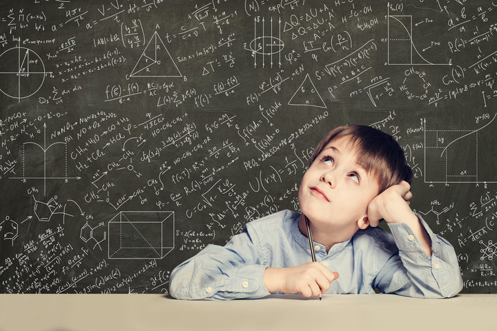 Gifted child with divergent thinking, staring thoughtfully at complex equations on chalkboard—symbolizing early systemizing intelligence and cognitive divergence in autism. Gifted child with divergent thinking, staring thoughtfully at complex equations on chalkboard—symbolizing early systemizing intelligence and cognitive divergence in autism.