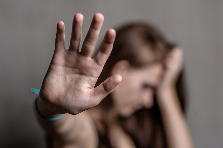 Woman holding her hand up in distress, symbolizing emotional blocks and inner resistance that obscure the brilliance beneath unresolved trauma and overwhelm. Woman holding her hand up in distress, symbolizing emotional blocks and inner resistance that obscure the brilliance beneath unresolved trauma and overwhelm.
