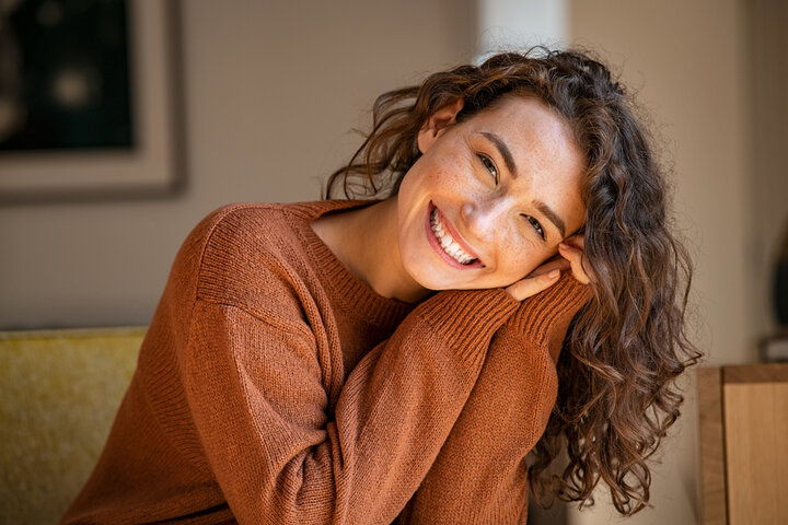 Joyful woman smiling with confidence and ease, representing the clarity, brilliance, and self-empowerment that emerge after emotional blocks are cleared. Joyful woman smiling with confidence and ease, representing the clarity, brilliance, and self-empowerment that emerge after emotional blocks are cleared.