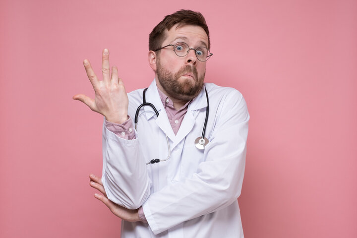 Confused doctor shrugging with raised hands, symbolizing uncertainty in the medical model's explanation of what causes severe autism. Confused doctor shrugging with raised hands, symbolizing uncertainty in the medical model's explanation of what causes severe autism.