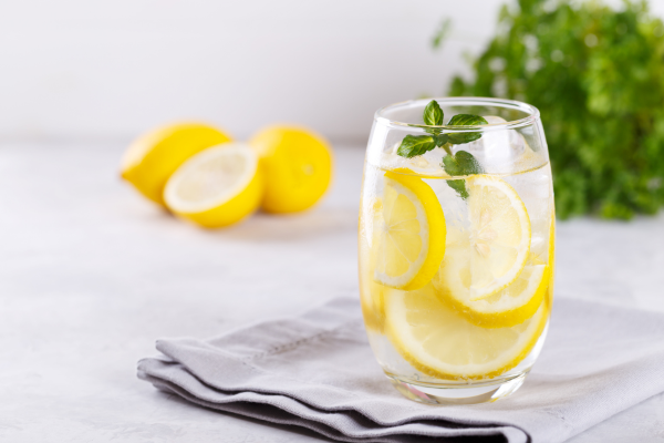 A refreshing glass of water with slices of lemon and strawberries. A refreshing glass of water with slices of lemon and strawberries.
