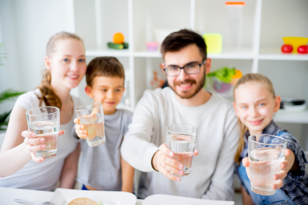 Family drinking water to help dental health Family drinking water to help dental health